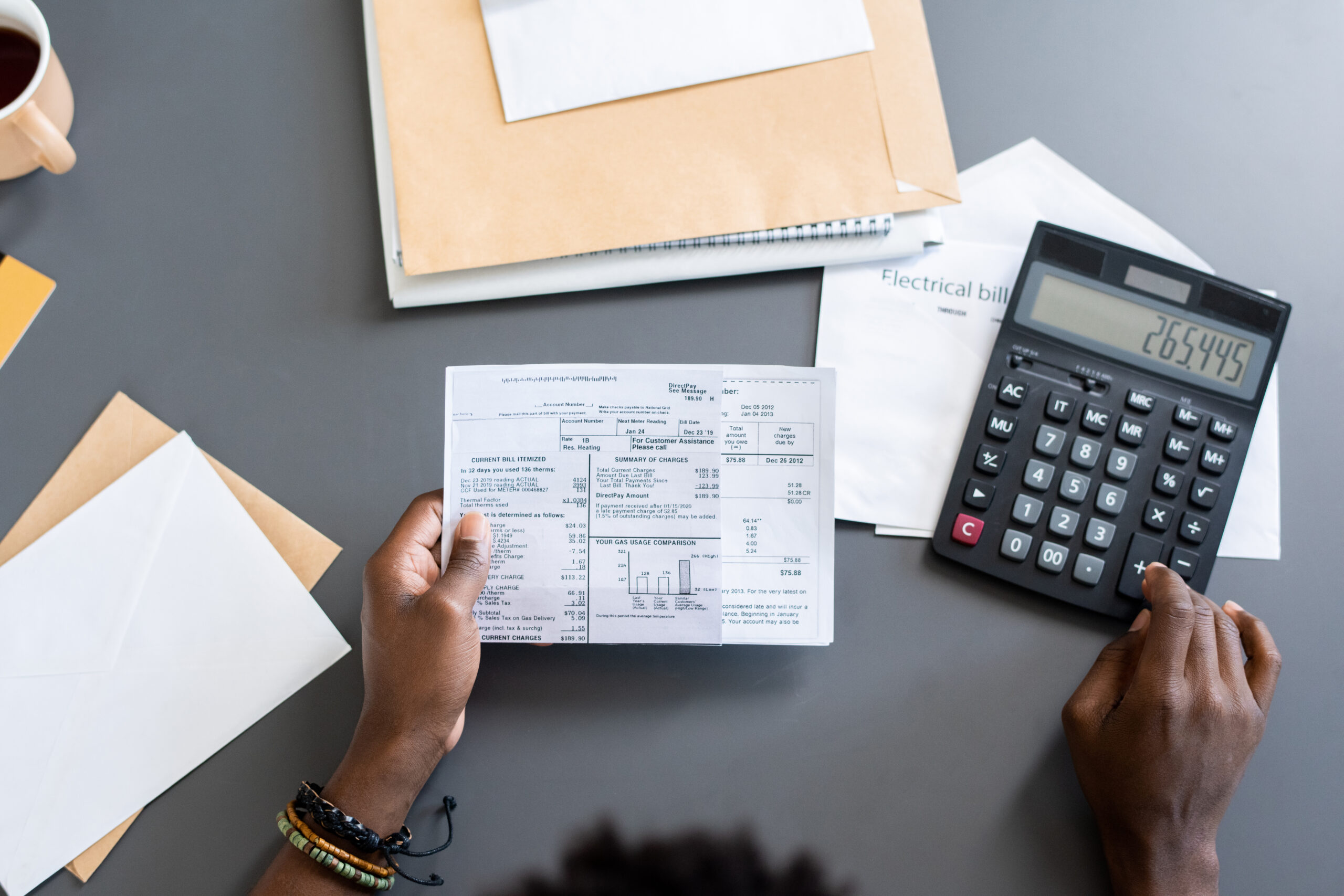 Person sitting at a desk and calculating finances.