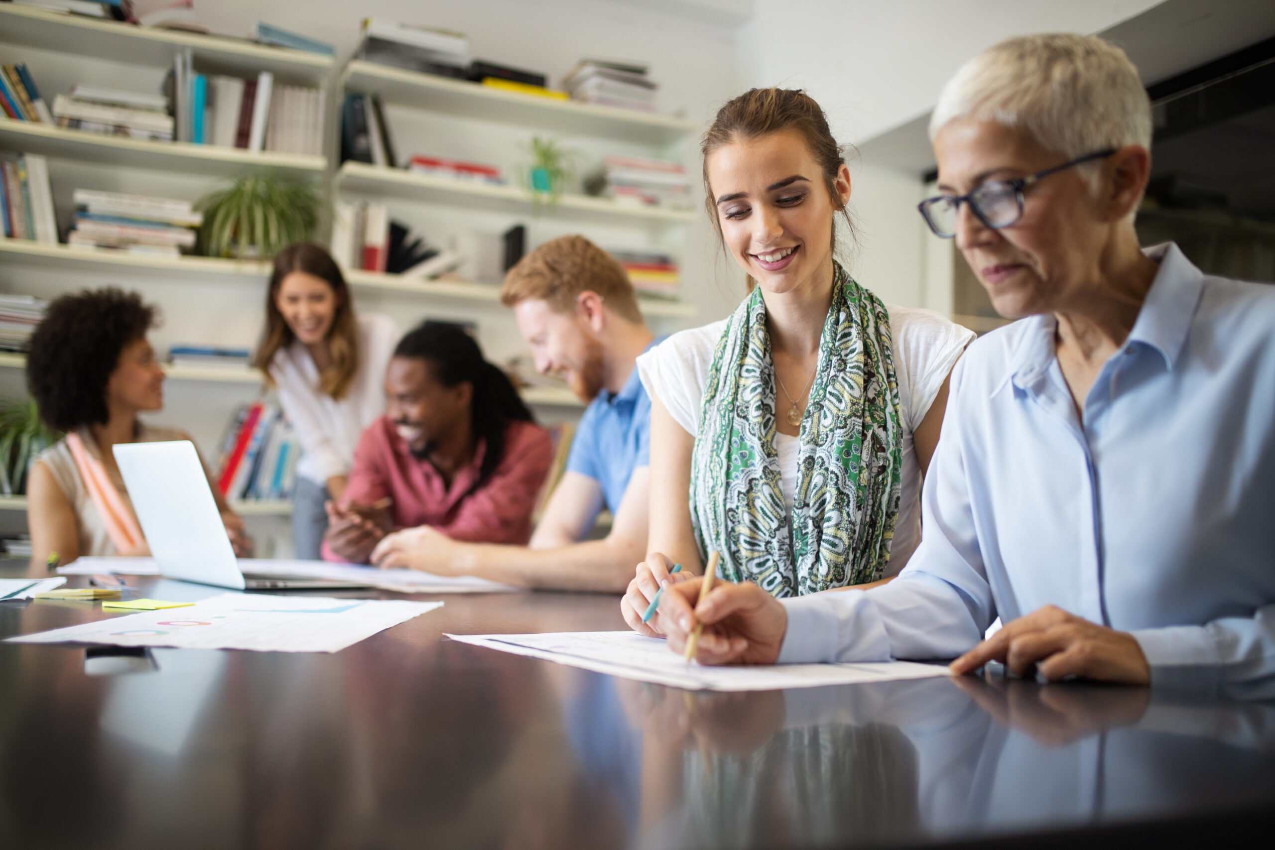 A group of colleagues of mixed age and race working on a project