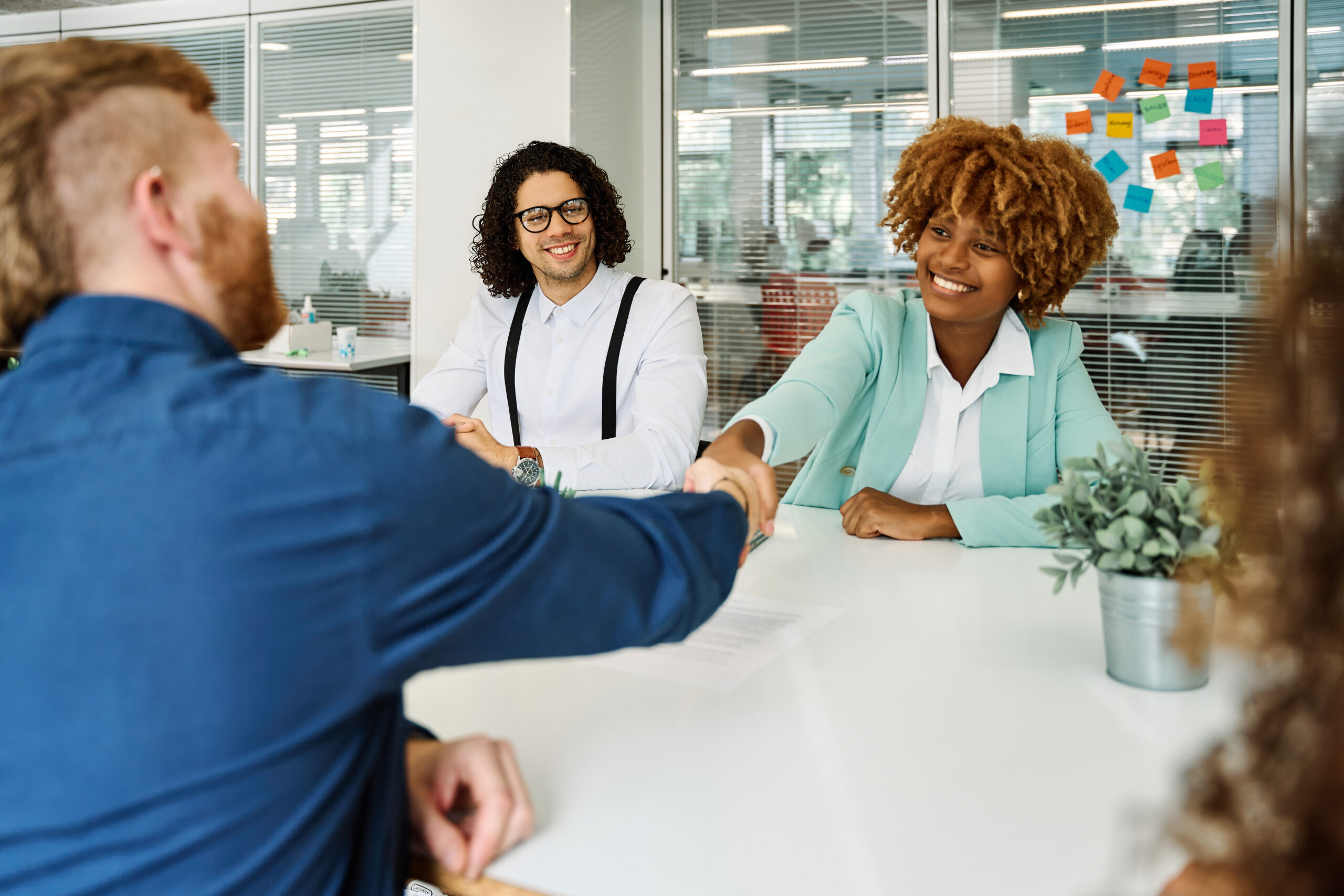 Multicultural people shaking hands during a meeting