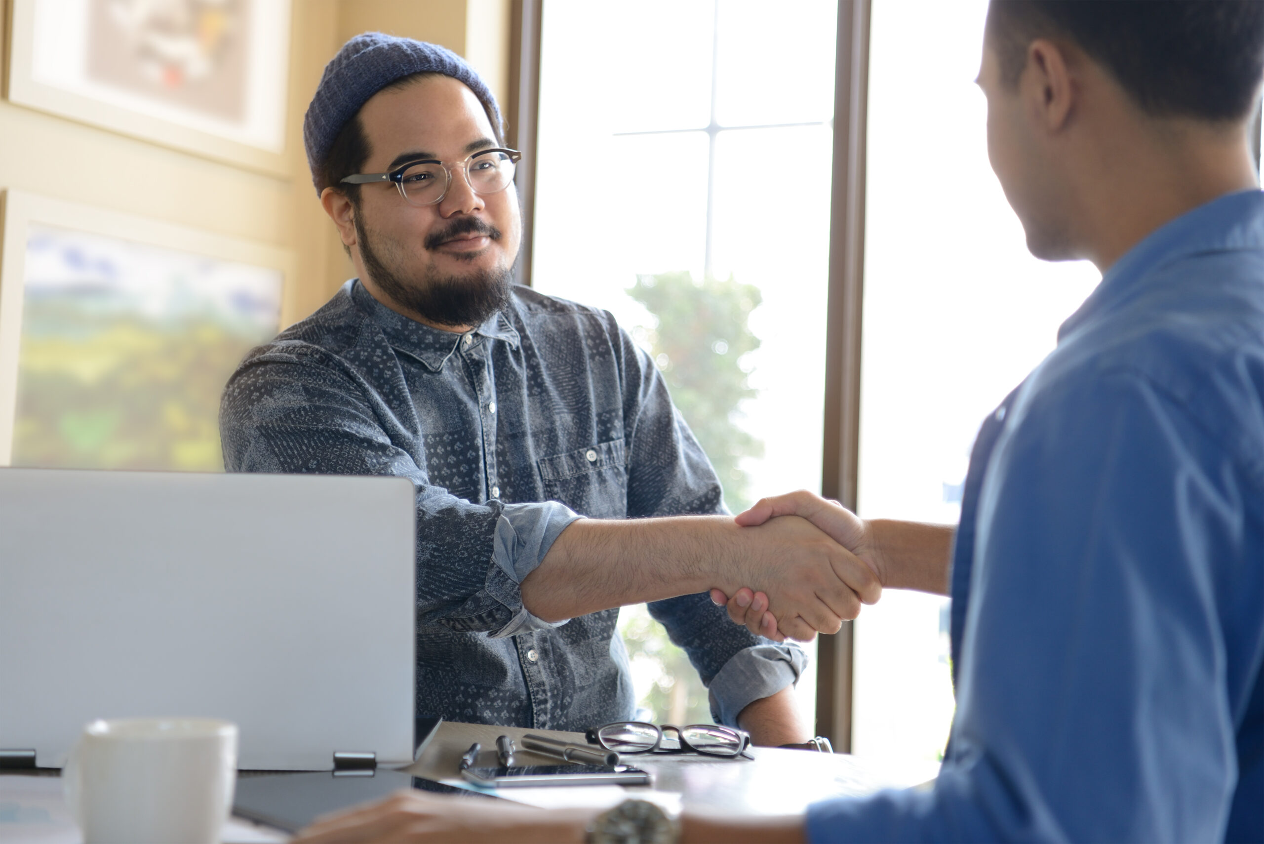 Two men shaking hands after a business meeting