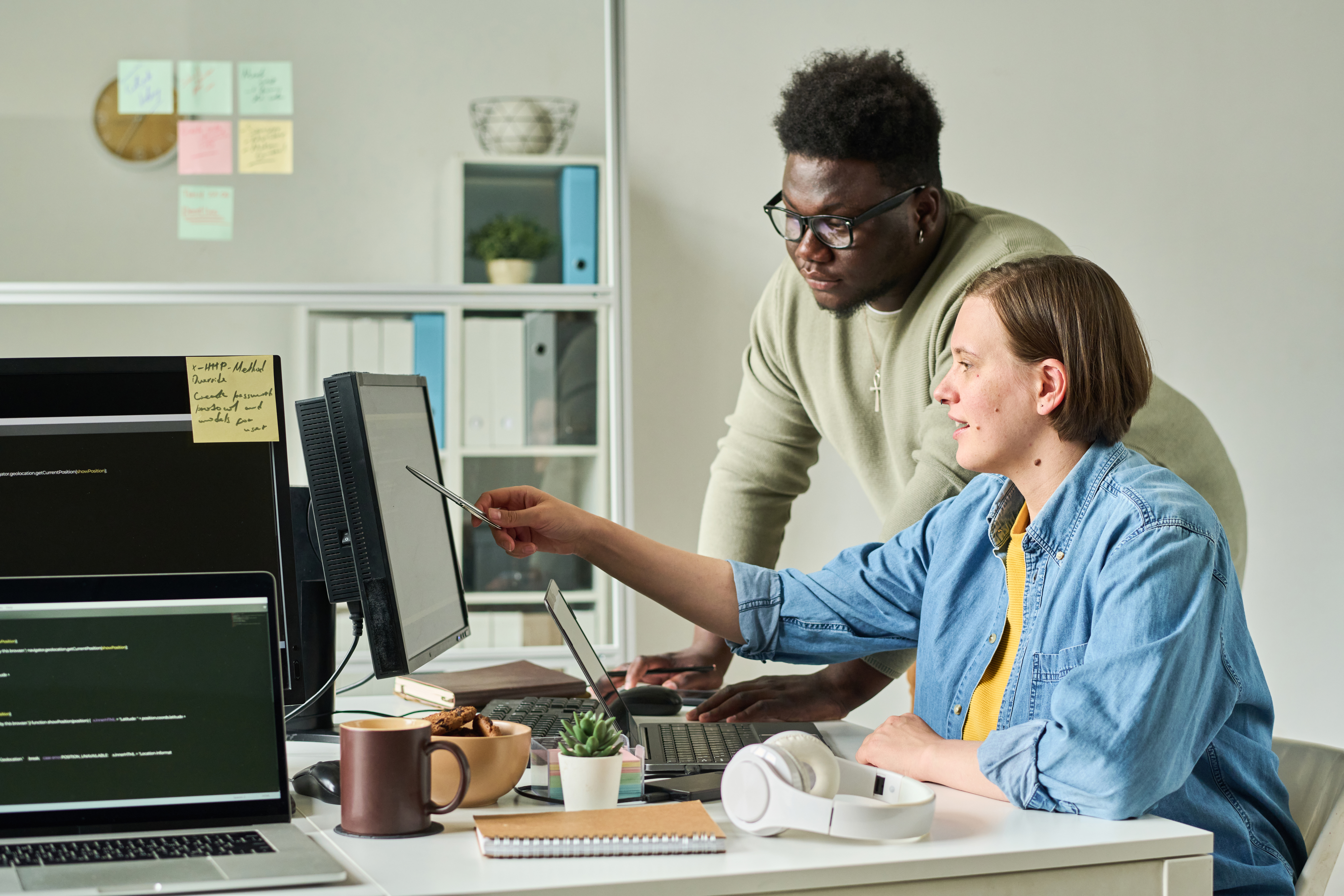 colleagues discussing a business presentation on a computer