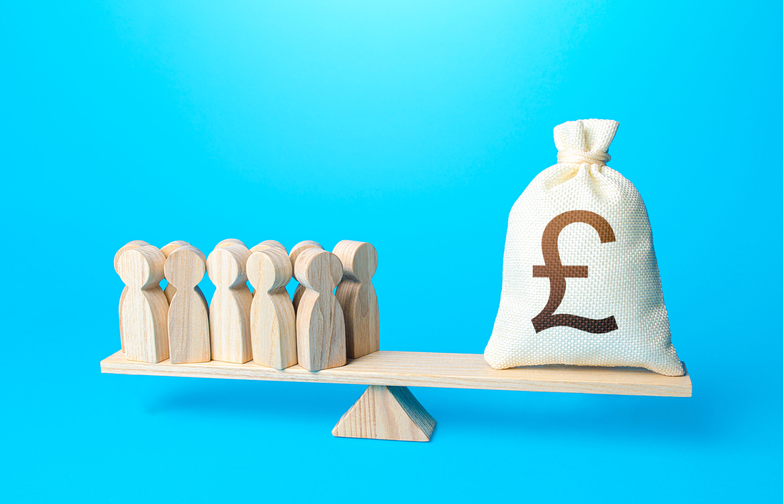 Two professionals collaborating at a desk with coins and a light bulb, symbolising financial planning and innovation.