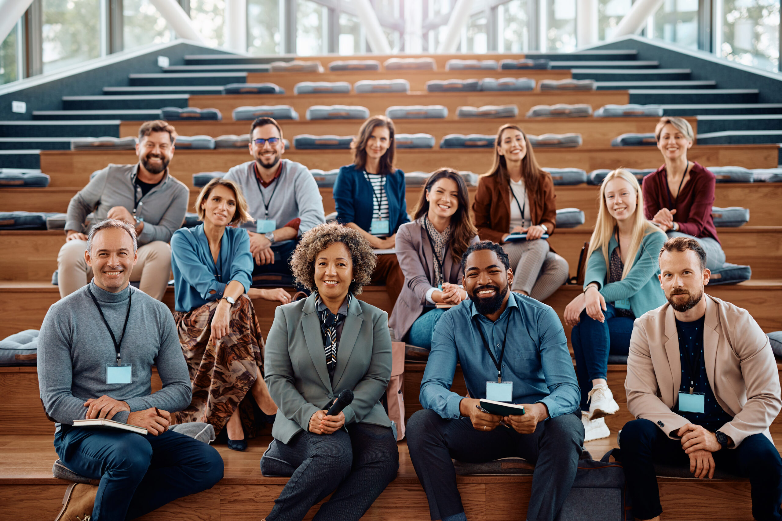 Multiracial group of happy business seminar attendees at convention center looking at camera. Group of business people attending a seminar
