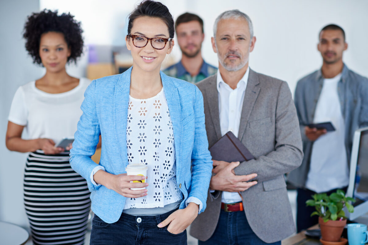 a group of business professionals looking condidently at the camera