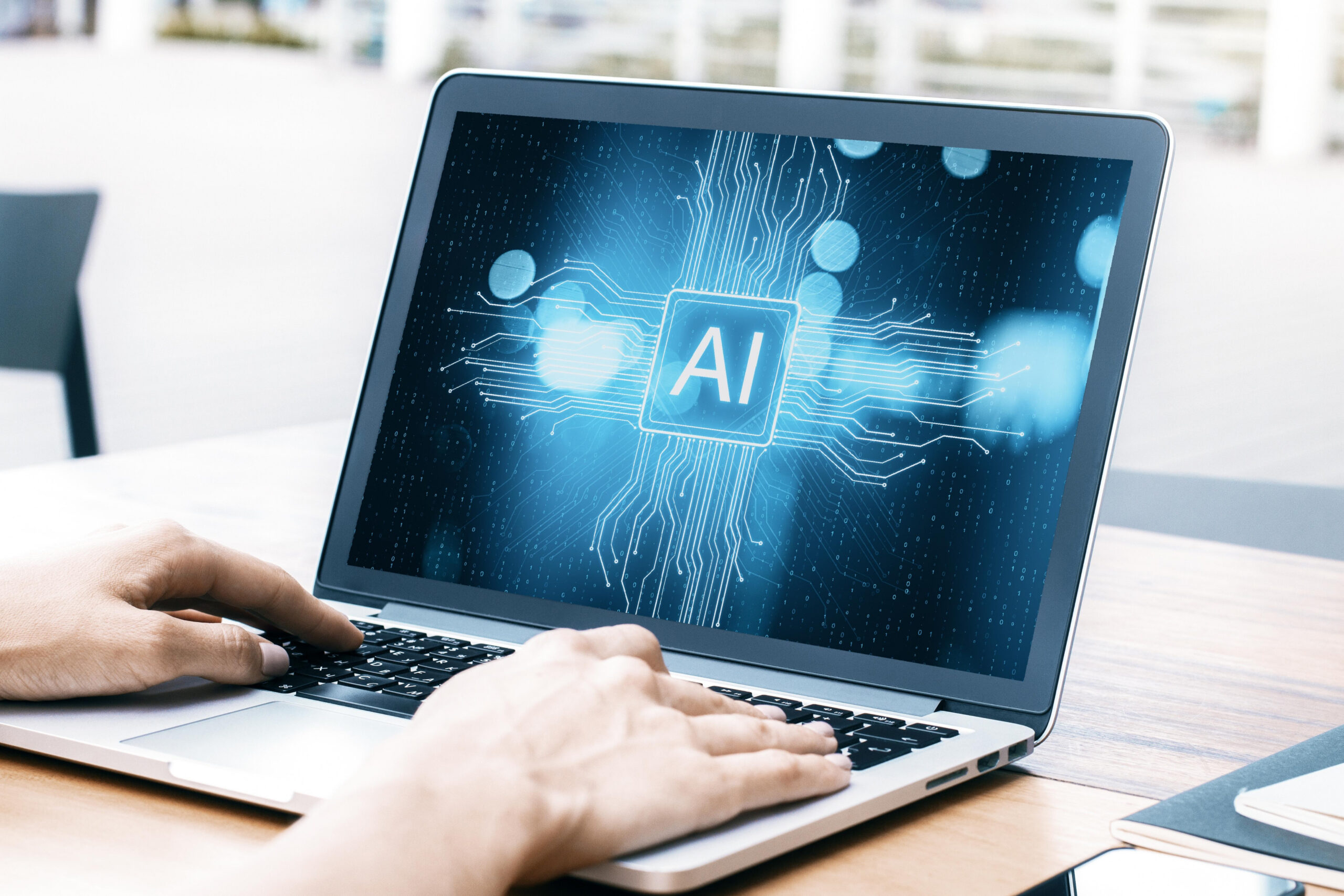 hands on a laptop displaying ai technology